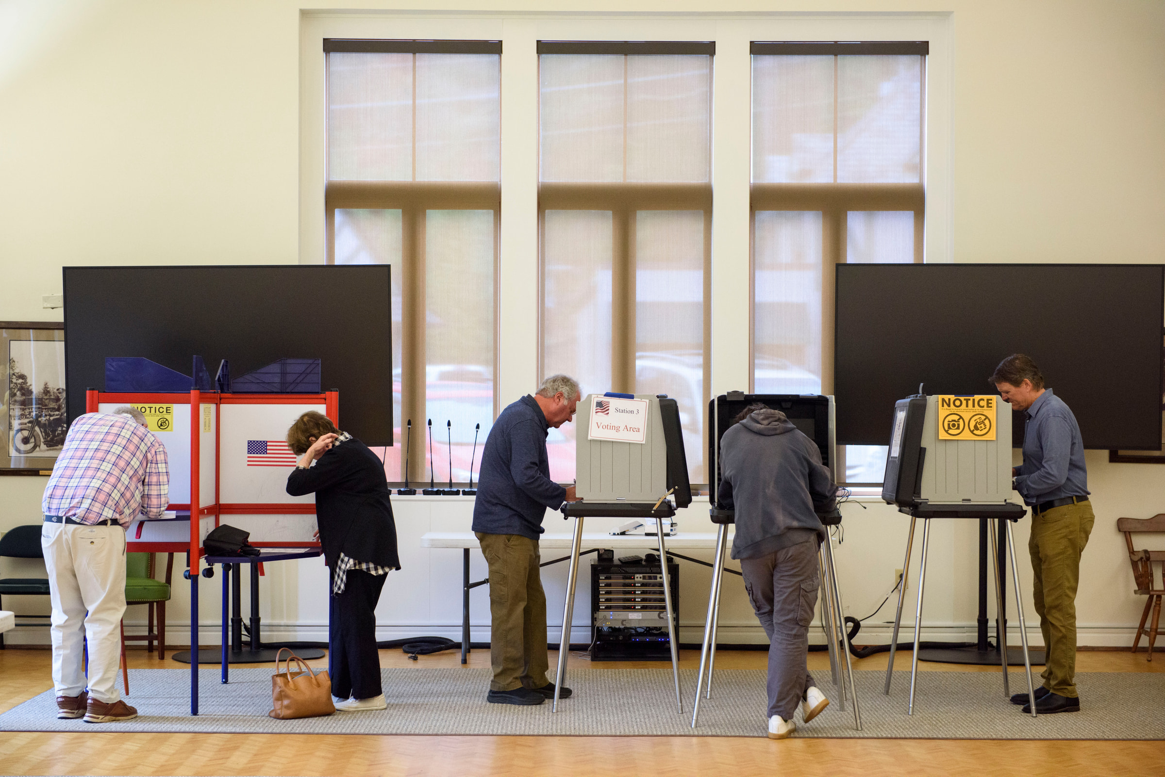 Voters cast ballots at voting stations inside a polling place.